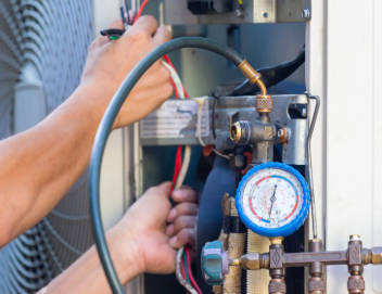 Technician checking refrigerant levels in AC system with precision gauges